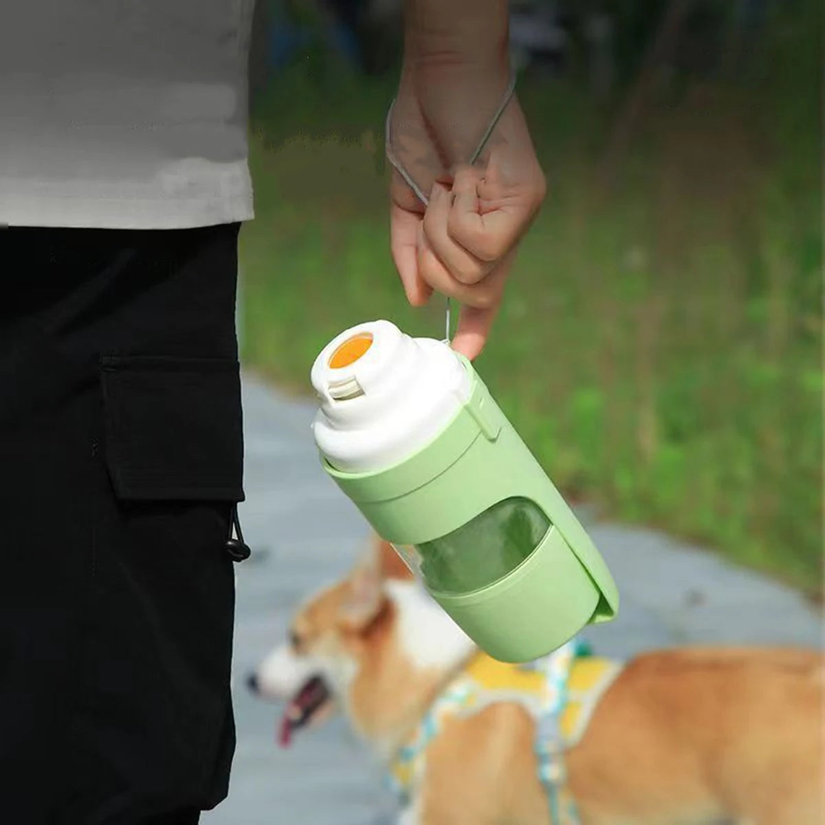 Portable Mon ami à quatre pattes dog water bottle with food container, showing the compact design and drinking spout.