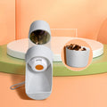 Portable dog water bottle with food container by Mon ami à quatre pattes, featuring a compact design for outdoor pet hydration.