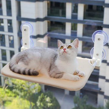 Wall mounted cat hammock window bed by Mon ami à quatre pattes, showing a cozy hammock attached to a window frame for cats.